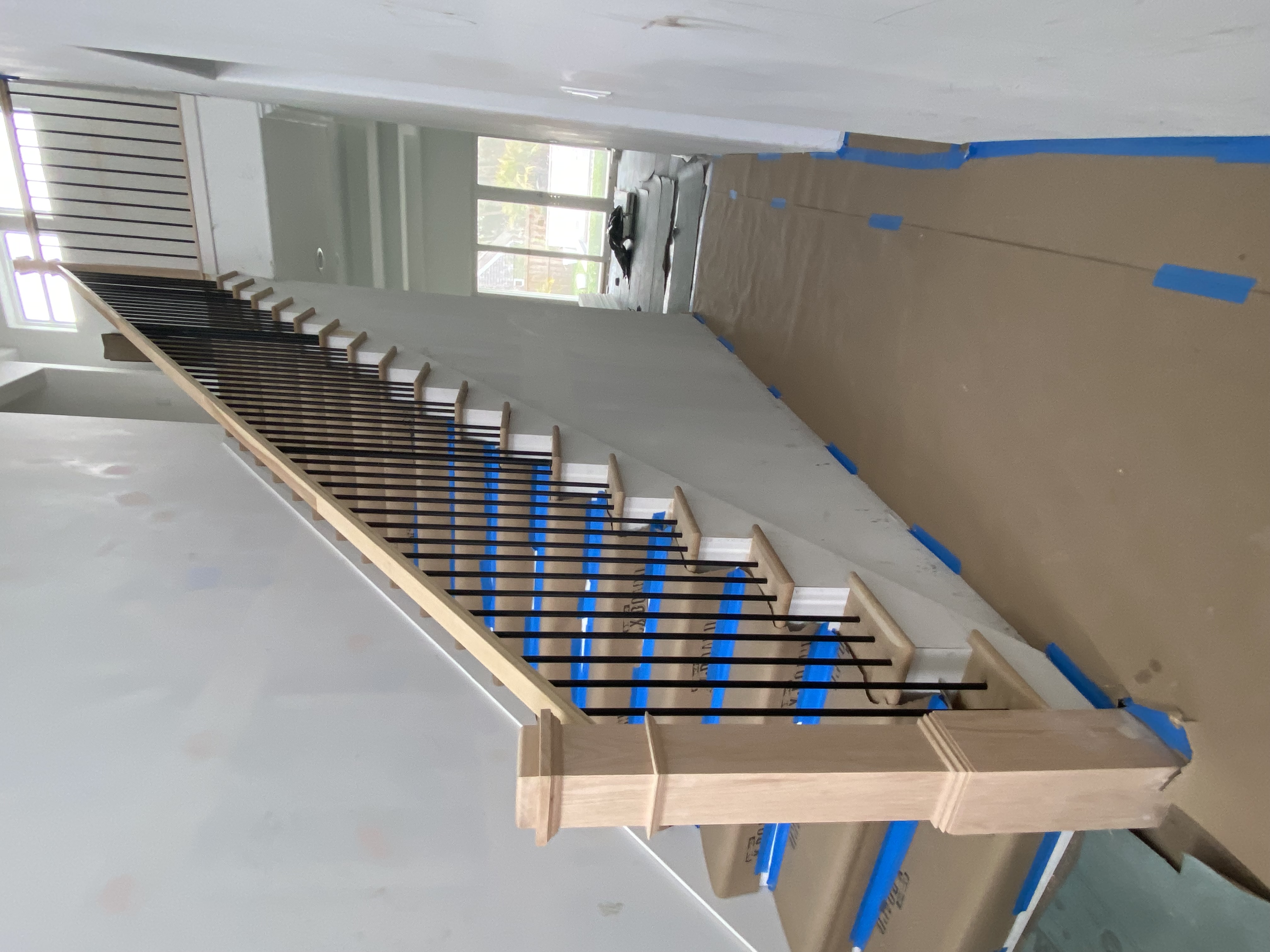 Custom staircase with metal balusters built by Coastal Living Construction